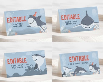 May include: Four blue and white printable food tent cards with a shark and ocean theme. The text on the cards reads "Editable Food Tent Template".