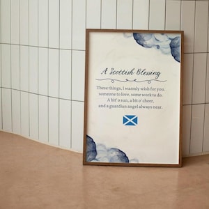 May include: A framed print with a white background and blue watercolour flowers. The print features a Scottish blessing that reads: "These things, I warmly wish for you. Someone to love, some work to do. A bit' o sun, a bit o' cheer, and a guardian angel always near." The print also features the Scottish flag.