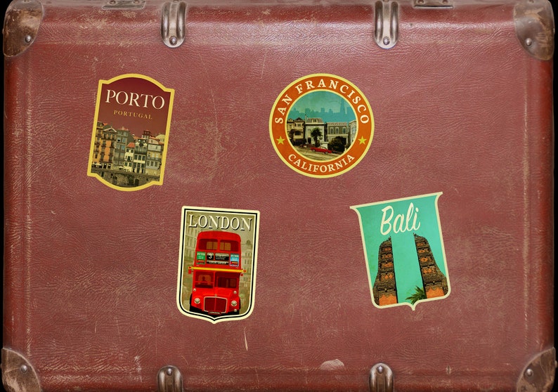 May include: A brown vintage suitcase with four travel stickers. The stickers are for Porto, Portugal; San Francisco, California; London, England; and Bali, Indonesia.