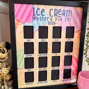 May include: A framed shadowbox with an ice cream theme. The background features pastel ice cream illustrations and sprinkles. It has 16 rectangular cutouts for pins, with character names like Alice and Buzz. Text reads "Ice Cream Mystery Pin Set 2026".
