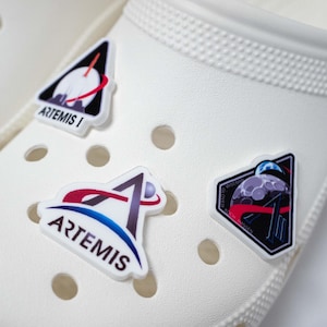 May include: A set of three ceramic mugs with a speckled, matte finish. The mugs are in shades of cream, light brown, and dark brown. Each mug has a simple, minimalist design, perfect for coffee or tea.