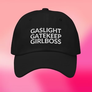 May include: Black baseball cap with white embroidered text that reads "GASLIGHT GATEKEEP GIRLBOSS".
