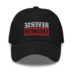 May include: Black baseball cap with white and red embroidered text that reads "REVERSE ENGINEER" in reverse.