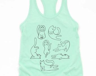 May include: A mint green tank top with a black line drawing of cats in various yoga poses. The cats are drawn in a simple, minimalist style.
