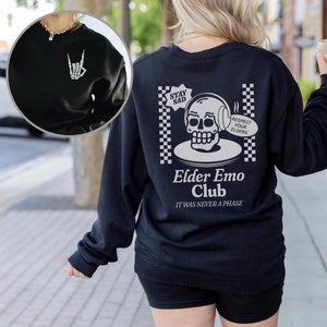 May include: Black sweatshirt with a white skull graphic and the text "Stay Sad, Respect Your Elders, Elder Emo Club, It Was Never A Phase".