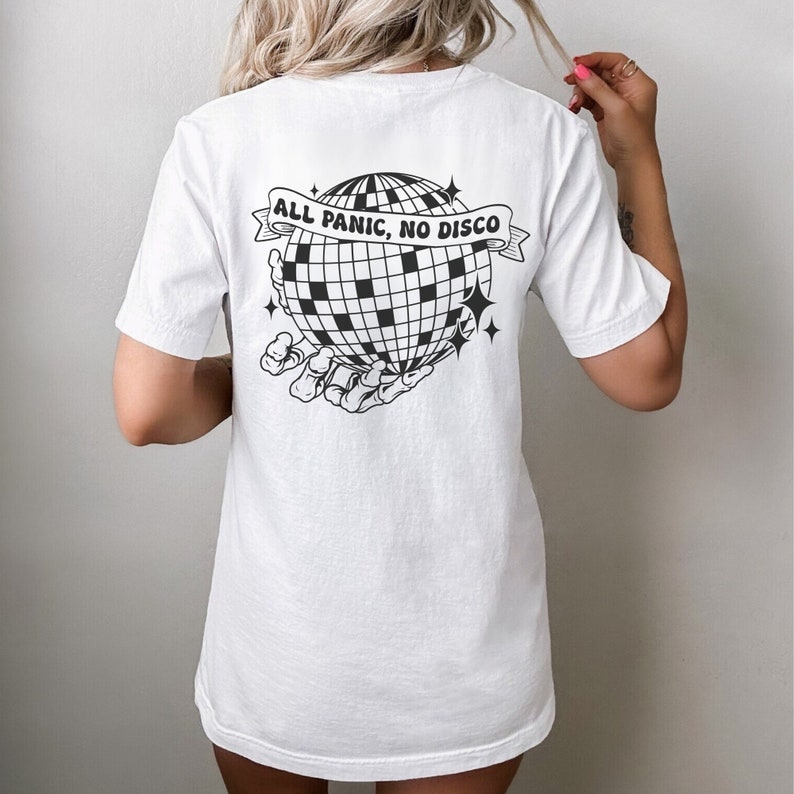 May include: White t-shirt with a black and white graphic of a disco ball being held by a skeleton hand. The text "ALL PANIC, NO DISCO" is on a banner above the disco ball.