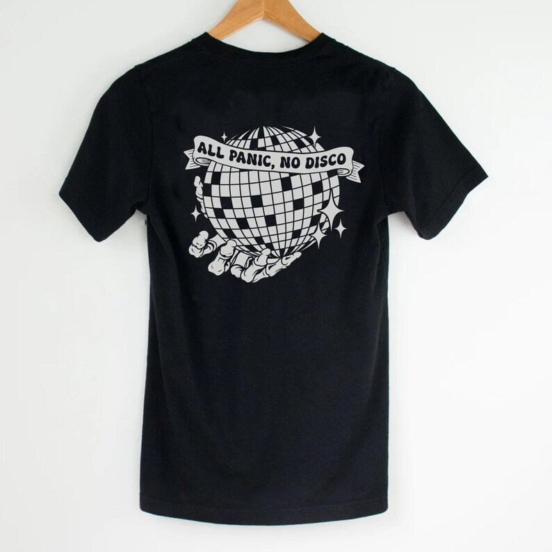 May include: Black t-shirt with a white graphic of a skeleton hand holding a disco ball. The text "ALL PANIC, NO DISCO" is on a banner above the disco ball.