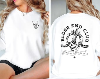 May include: White sweatshirt with a black skull graphic and the text "Elder Emo Club" on the back. The front of the sweatshirt has a black skeleton hand graphic making a rock and roll sign.