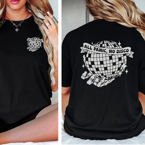 May include: Black t-shirt with a white graphic of a disco ball in a skeletal hand with the text "ALL PANIC, NO DISCO" on the back.