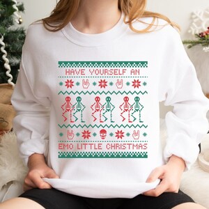 K&ouml;nnte beinhalten: Wei&szlig;er Weihnachtspullover mit einem gr&uuml;n-roten Design mit tanzenden Skeletten und dem Text "Have Yourself an Emo Little Christmas".