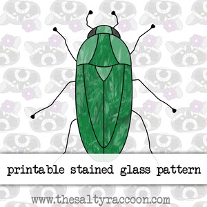 May include: Printable stained glass pattern of a green beetle with black legs and antennae. The pattern is on a white background with a repeating pattern of small grey racoons.