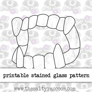 May include: Printable stained glass pattern of a set of fangs. The pattern is outlined in black and has a marbled texture.