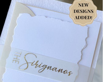 May include: White wedding invitation with a cream colored border and a white inner layer with a gold foil inscription that reads "The Stigmanos".