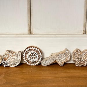 May include: A set of three ceramic mugs with a speckled, matte finish. The mugs are in shades of cream, light gray, and dark gray. Each mug has a simple, minimalist design, perfect for coffee or tea.