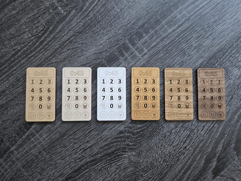 May include: Six wooden timer cards with a white background and black numbers. Each card has the text "0:45" at the top and numbers 1 through 9 in a grid pattern. The cards are arranged in a row from left to right.