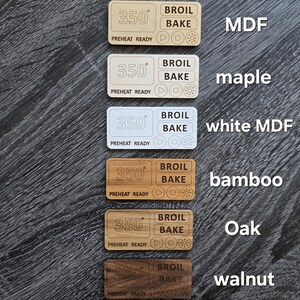 May include: Six wooden oven knobs with different wood finishes: MDF, maple, white MDF, bamboo, oak, and walnut. Each knob features a digital display with the temperature set to 350 degrees Fahrenheit, and buttons for broil and bake.