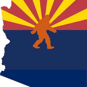 May include: A blue and red flag with a yellow sunburst design and a silhouette of a Bigfoot walking across the center. The flag is shaped like the state of Arizona.