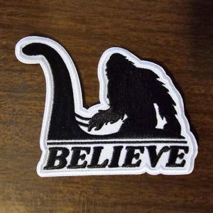 Bigfoot Sasquatch Riding the Loch Ness Monster Patch – 3.5" Cryptid Yeti Emblem for Hat, Jacket, Coat & Backpack