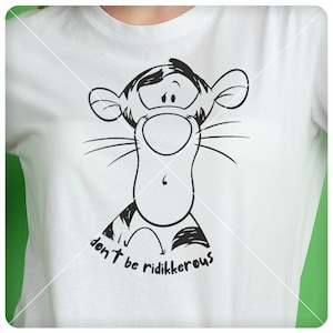 May include: A white t-shirt with a black and white illustration of Tigger from Winnie the Pooh. The illustration shows Tigger with a surprised expression and the text "don't be ridikkerous".
