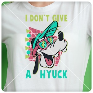 May include: White t-shirt with a cartoon dog wearing sunglasses and a hat. The text "I don't give a hyuck" is printed on the shirt.