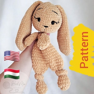 May include: A crocheted beige bunny toy with long floppy ears. The bunny has black eyes and a stitched smile. The toy is held in a person's hand. The image includes the text "Pattern" in yellow.