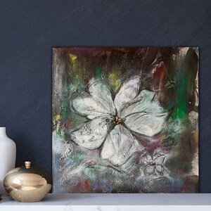 May include: Abstract painting of a white flower with a dark background. The flower is painted in a realistic style, with details of the petals and center. The background is a mix of dark colors, with hints of green and yellow.