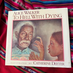 May include: A hardcover book titled "Alice Walker To Hell With Dying" with an illustration of an elderly man and a young person. The cover art is framed in pink, with the illustrator's name at the bottom.