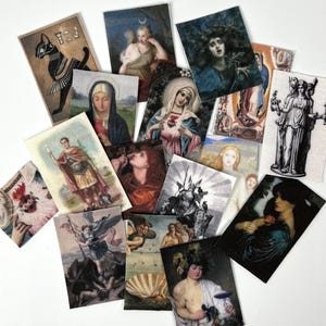 May include: A collection of rectangular art prints featuring various classical paintings and illustrations. The prints depict religious figures, mythological scenes, and portraits, with a variety of colors and styles. The prints are arranged on a white surface.