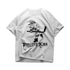 May include: A gray t-shirt with a black and white illustration of a hockey player with a stick and the text "PENALTY KILL" in a gothic font.