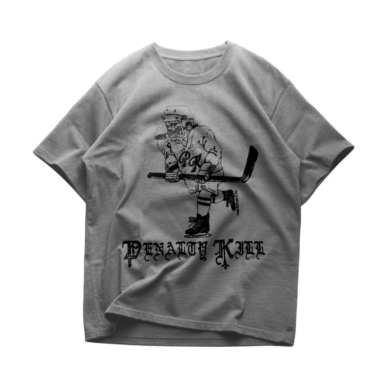 May include: Gray t-shirt with a black and white illustration of a hockey player with a stick and the text "Penalty Kill" in a gothic font.