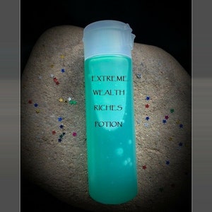 May include: A clear plastic bottle with a green liquid inside. The bottle has a white label with the text "EXTREME WEALTH RICHES POTION" printed on it.