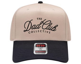 May include: A beige and black baseball cap with the text "The Dad Club Collective" in black script. The cap has a curved brim and a button on top. The label reads "OTTO Classic Fit OSFM Mid Profile".