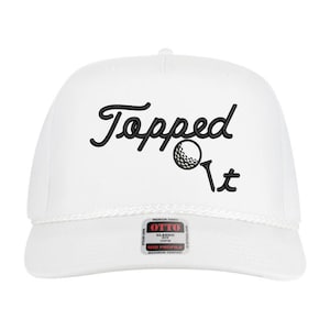 May include: White golf hat with the embroidered text "Topped It" in black script, along with a golf ball graphic. The hat has a rope detail and a small patch that reads "OTTO".