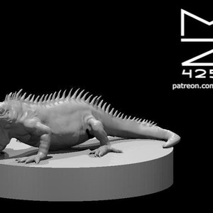 May include: A gray 3D printed model of a lizard with a spiky back, posed on a round base. The model is detailed and realistic.