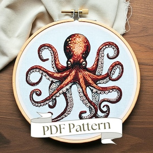 Peut inclure: Patron d'octopus brodé dans un cercle de broderie en bois. La pieuvre est rouge avec des points blancs et a huit tentacules. Le fond est bleu clair. Le texte "PDF Pattern" est sur une bannière brune.