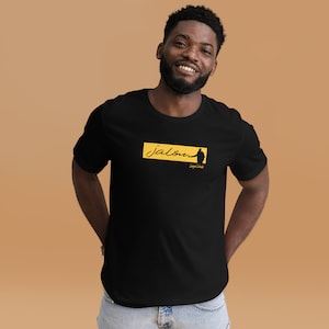 May include: Black t-shirt with a yellow rectangle featuring the text "jalou" and a silhouette of a person. The text "Leggero Caldo" is below the silhouette.