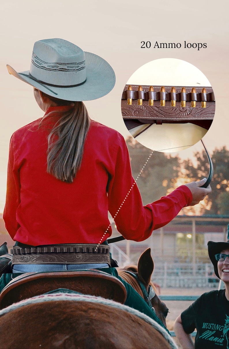 May include: A brown leather belt with 20 ammo loops. The belt is worn by a person wearing a red shirt and a light gray cowboy hat. The person is riding a brown horse. The belt has a decorative floral pattern.