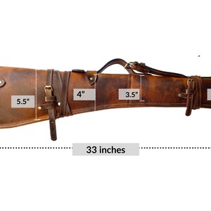 May include: A brown leather gun case with a strap and buckles. The case measures 33 inches long, 7 inches wide at the widest point, and 5.5 inches wide at the narrowest point. The case has a 4 inch wide flap and two 3.5 inch wide straps.
