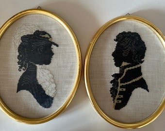 Two oval gold frame with needlepoint embroidery