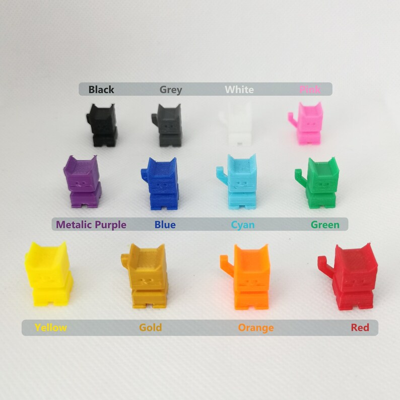 May include: A set of 12 small, colorful cat figurines. Each figurine is made of plastic and has a different color, including black, grey, white, pink, metallic purple, blue, cyan, green, yellow, gold, orange, and red.
