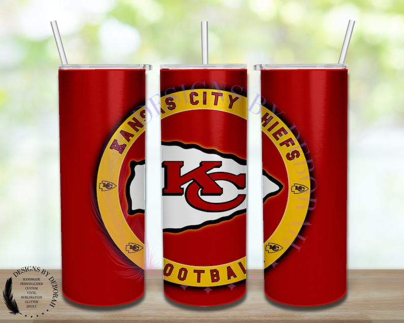May include: A red stainless steel tumbler with a gold circle around the Kansas City Chiefs logo. The logo is a red and white "K" inside a red and white arrowhead. The text "Kansas City Chiefs Football" is around the logo.
