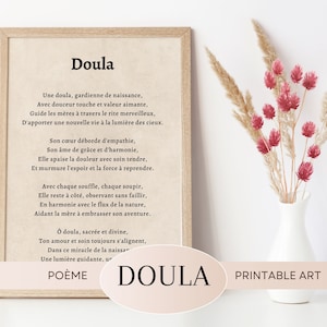 May include: A framed print featuring the word "Doula" and a poem in French. The artwork has a beige background and a light brown frame. A vase of dried flowers with red accents sits to the right. The words "Poème" and "Printable Art" are also visible.