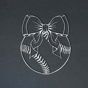 May include: A white metal baseball with a white bow tied around it. The baseball has stitching details.