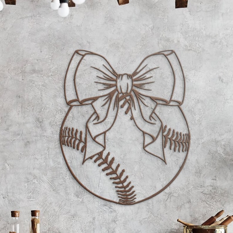 May include: A brown baseball with a large bow tied around it. The baseball is outlined in a dark brown color and the bow is made of a thin, brown line.