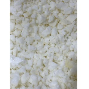 May include: Close-up of a pile of white foam pieces. The foam is irregularly shaped and appears to be shredded or cut into various sizes. The texture is soft and porous, with a slightly off-white color.