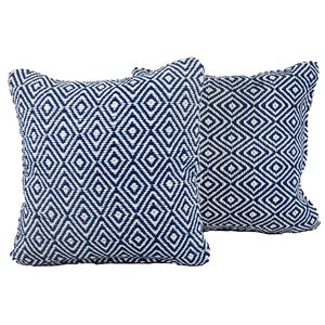 May include: Two blue and white patterned throw pillows with a diamond design.