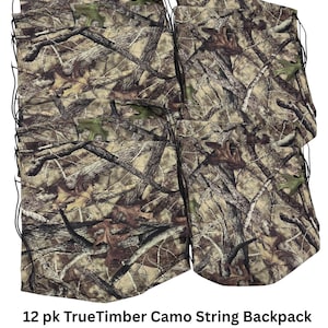May include: A collection of TrueTimber camo string backpacks. Each backpack features a pull string closure and a camouflage pattern in shades of brown, green, and tan. The backpacks are approximately 16 inches wide and 18.5 inches tall.