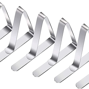 May include: Set of six silver triangle-shaped table clips. The clips are designed to hold tablecloths or napkins in place.