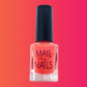 May include: A clear glass bottle of coral orange nail polish with a black cap. The bottle has the text "MAIL my NAILS" printed on the front.