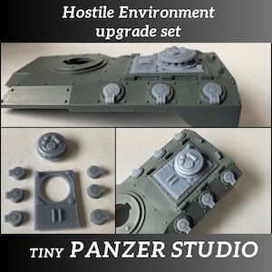 May include: A set of grey plastic tank model upgrade parts for a wargaming miniature. The set includes a turret hatch, a variety of small round details, and a larger rectangular piece with two slits. The set is labeled "Hostile Environment upgrade set" and "TINY PANZER STUDIO".